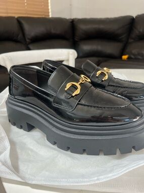 Stuart Weitzman Black Patent Chunky Lug Loafers with Gold Hardware